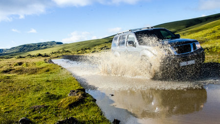 A view of a car on a gravel road in Landmannalaugar, Iceland captured on a sunny dayの写真素材