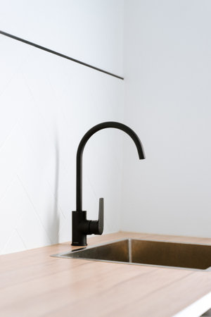 The beautiful modern style black faucet with steel sink in the kitchenの写真素材