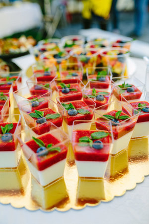 A vertical shot of pudding with fruits in cupsの写真素材