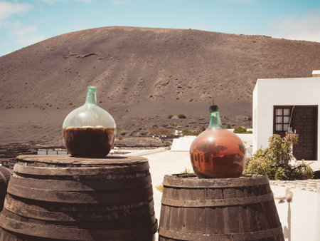 A closeup shot of round glass containers with liquid outdoors