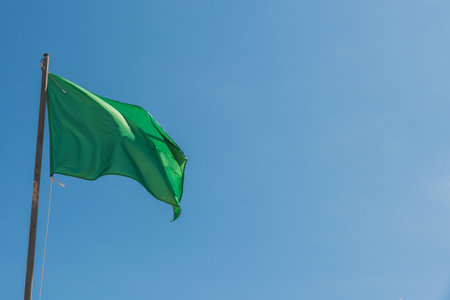 The waving green flag indicating the calmness of the seaの写真素材
