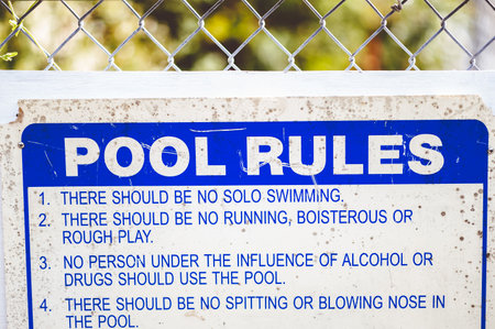 A closeup focus shot of 'pool rules' sign - summer theme