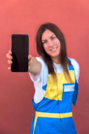 A closeup shot of a young female with her smartphone posing at camera