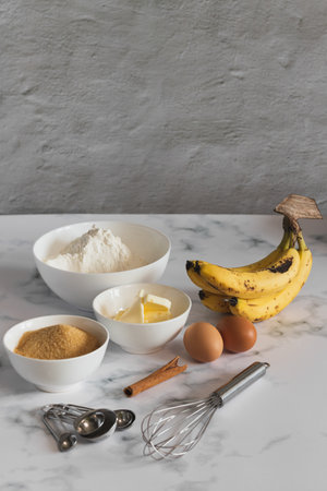A vertical shot of ingredients for baking banana bread in the kitchenの写真素材