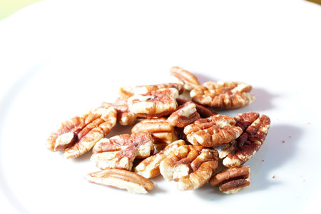 A closeup shot of pecans on white surfaceの写真素材