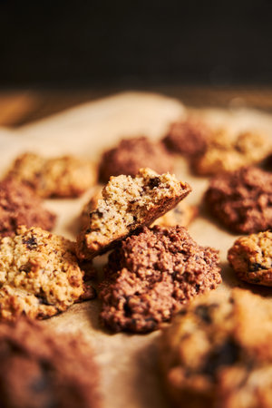 A vertical closeup shot of a bitten oatmeal cookie on a platterの写真素材