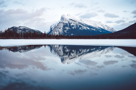 A beautiful shot of Mount Rundle Banff reflecting in the water in Canada