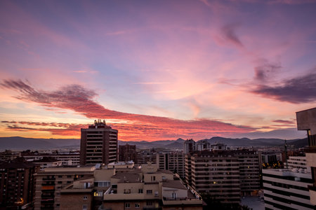 A high angle shot of buildings and the cloudy sky during sunset in Pamplona, Spainの写真素材