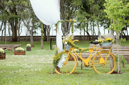 The decorated yellow bicycle  in the beautiful parkの写真素材