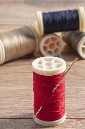 A vertical shot of threads rolls with a needleの写真素材