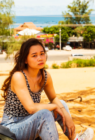 A vertical shot of a beautiful Asian female in Mui Ne town, Vietnamの写真素材