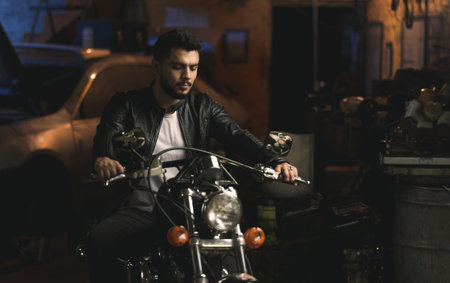 A male sitting on a motorcycle