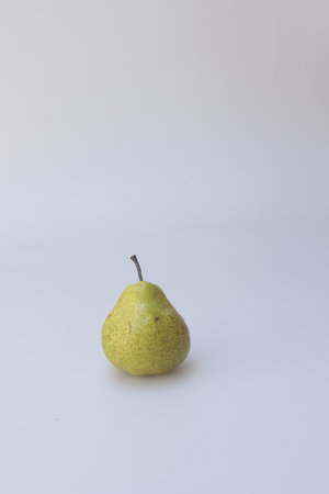 A vertical shot of a pear isolated on a gray backgroundの写真素材