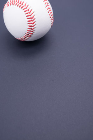 A vertical shot of a baseball ball isolated on blue background