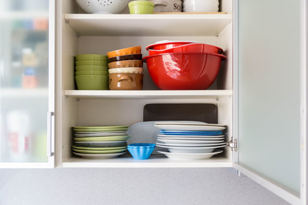 A shelf with plates, bowls and cups at home