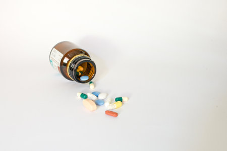 A closeup shot of pills fallen out of the box isolated on white backgroundの写真素材