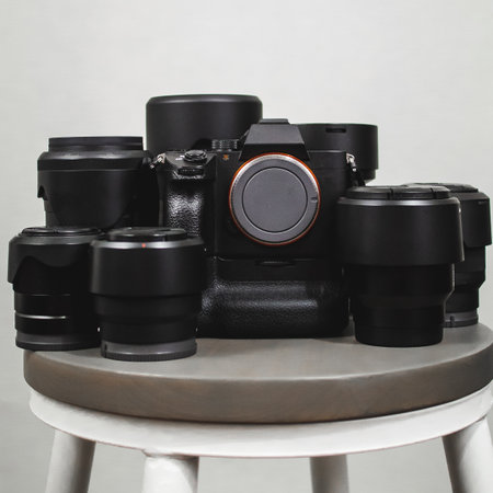A closeup shot of a black professional camera with various lenses