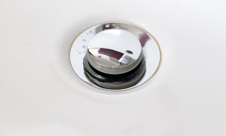 A high angle shot of a chrome sink drainの写真素材
