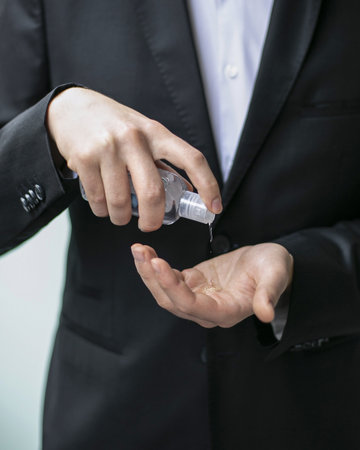 A closeup shot of a person using a hand sanitizer - concept of the new normal
