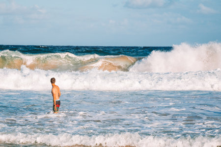 A man standing on the channel of Kauai island, Hawaiiの写真素材