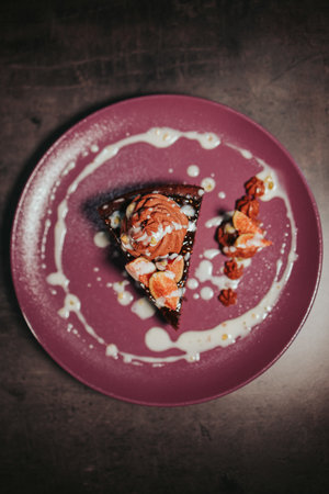 A vertical shot of a chocolate cake in a plateの写真素材
