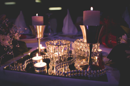 A closeup of candles, beads and other decorations at the table for the partyの写真素材