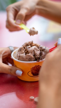A vertical selective focus shot of chocolate ice cream on a table