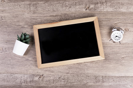 A top view of a small chalkboard on a wooden surfaceの写真素材