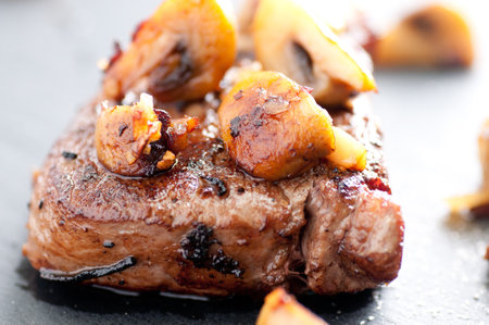 deliciously grilled beef tenderloin steak done rare with sauteed mushroomsの写真素材