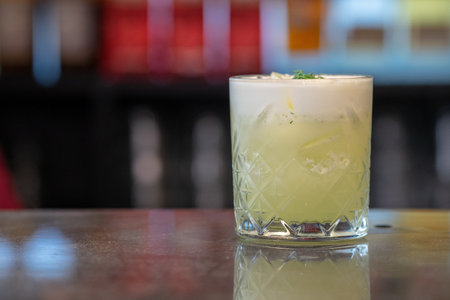 A closeup shot of original alcohol cocktails in a bar table with a blurred backgroundの写真素材