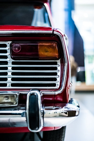A vertical shot of the back part of a vintage classic red carの写真素材