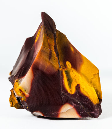A closeup shot of mookaite gemstone isolated on a white backgroundの写真素材