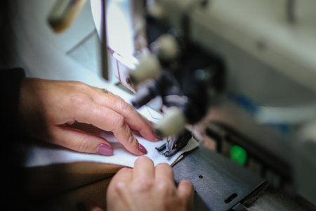 A closeup shot of a female operating an industrial sewing machine