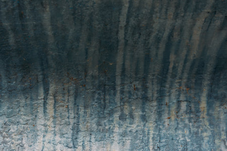 A closeup shot of a weathered blue wall