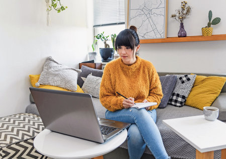 A young female student having an online class from home