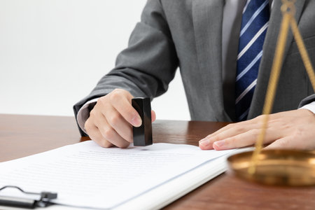 A closeup shot of a businessman signing some official papersの写真素材