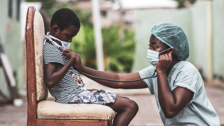 An African-American boy getting a checkup by a doctorの写真素材
