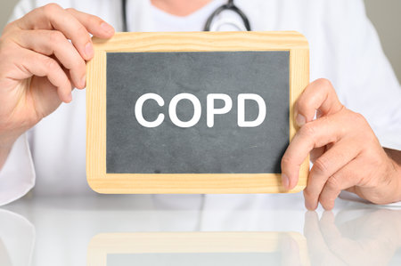 A doctor holding a board with COPD word on itの写真素材