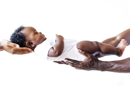 Parents holding an infant African-American baby boyの写真素材