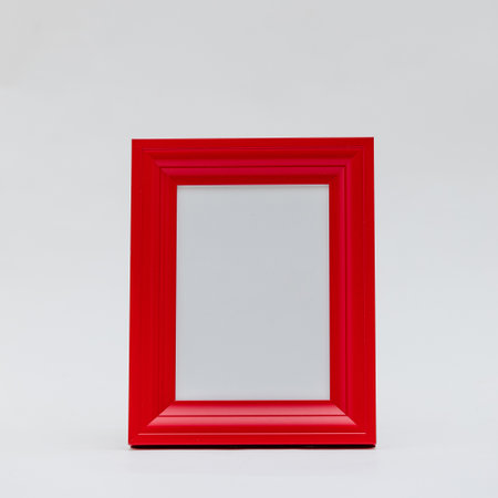 A vertical shot of a red photo frame on an isolated white backgroundの写真素材