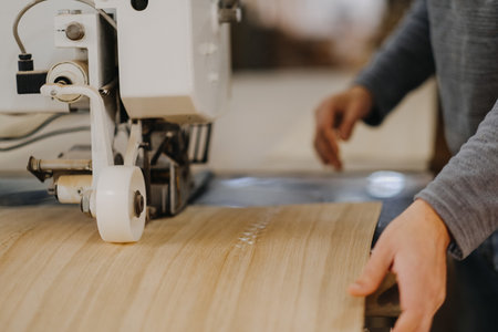 A closeup shot of a carpenter working on a piece of plywoodの写真素材
