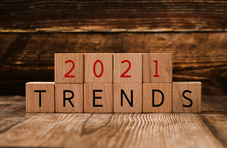 '2021 trends' written on wooden cubes on a wooden background.の写真素材
