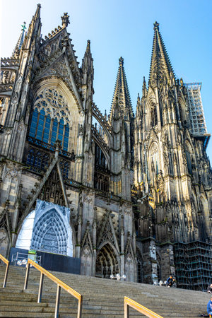 A vertical shot of a historic Cologne Cathedral exterior wall architectural patters under a clear skyの写真素材