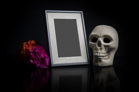 A photo frame with death decorations isolated on a black backgroundの写真素材