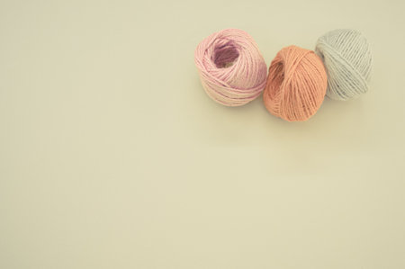 Three colorful yarn balls for knitting isolated on gray backgroundの写真素材
