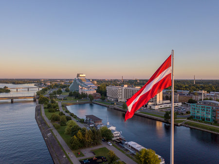 A closeup of the flag of Latvia in the AB Dam park under the sunlight in Rigaの写真素材