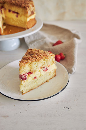 A vertical closeup shot of the delicious Vanilla cream cake with strawberries inside on a white...