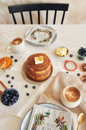 A closeup of the freshly made delicious pumpkin pancakes with butter and honey for breakfastの写真素材