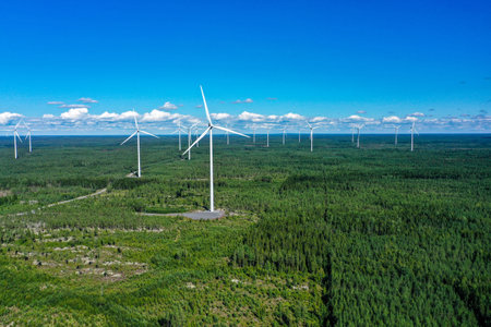 Aerial view of many windmills at a wind power farm, on a sunny, summer day, in Satakunta, Finland - Dolly, drone shotの写真素材
