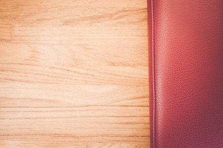 An overhead of natural red leather and wood texture with copy spaceの写真素材